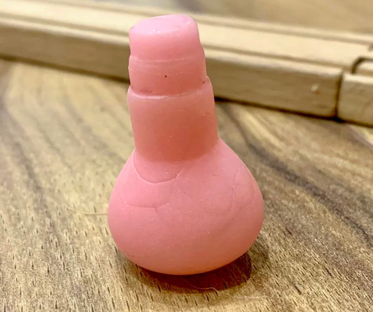 A pink object on a wood surface.